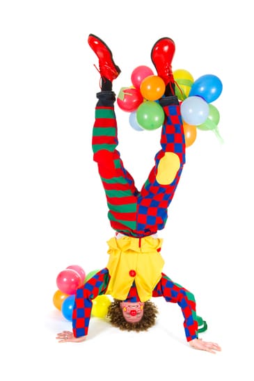 Funny clown in headstand